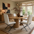 Set of cream faux leather dining chairs with black steel cross legs in a modern dining room – Chair Outlet